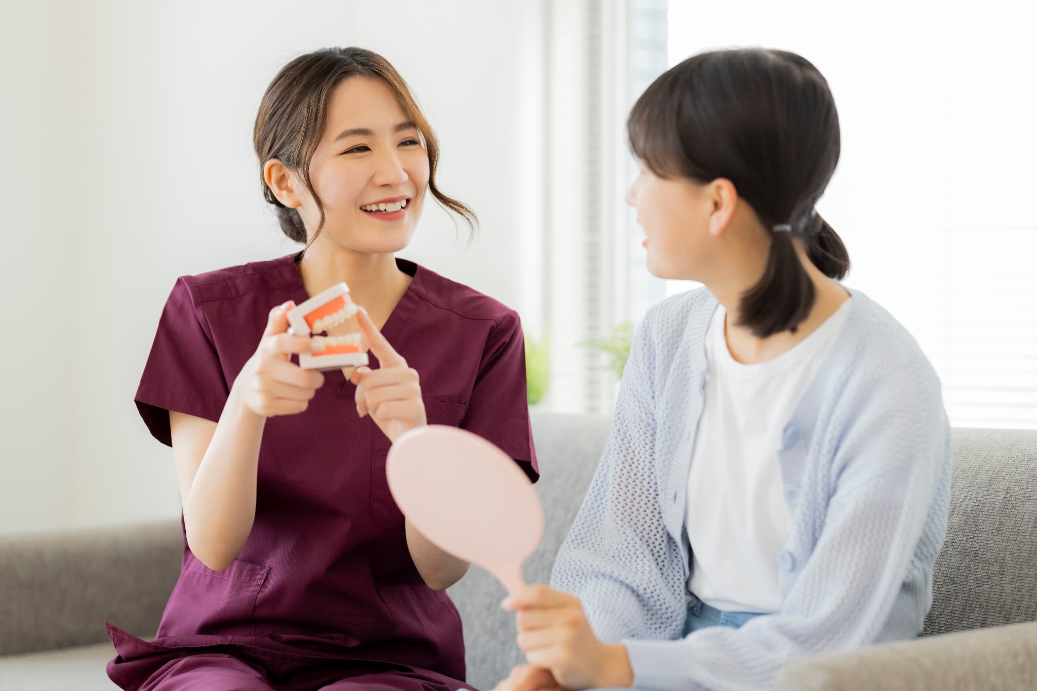 歯科保健指導をする歯科医師の女性